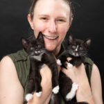 bruisin' holding two kittens