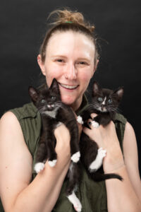 bruisin' holding two kittens